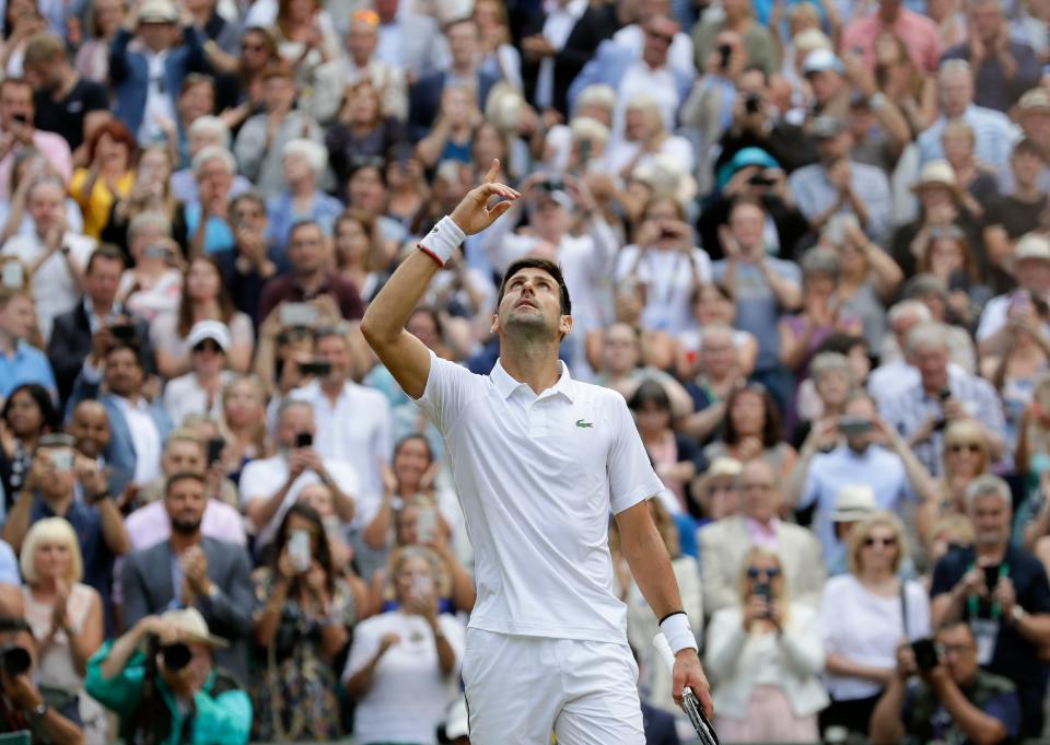 Serbia's Novak Djokovic celebrates defeating Switzerland's Roger Federer in the men's singles final match of the Wimbledon Tennis Championships in London, Sunday, July 14, 2019. (AP Photo/Kirsty Wigglesworth)
