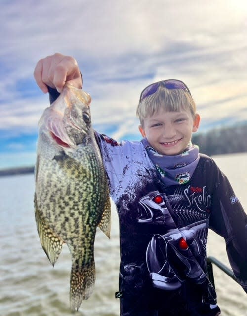 Aedan Petty, 10, from Crawfordville, holds up a nice Crappie (speckled perch), caught while fishing with Capt. Paul Tyre.