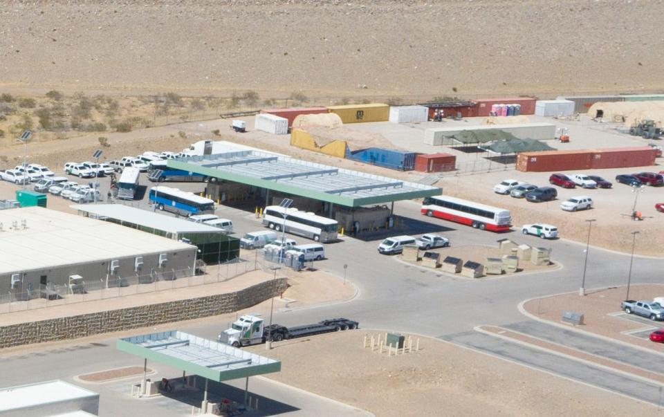 Buses arrive at the U.S. Border Patrol Central Processing Center in Northeast El Paso on March 12, 2021, as migrants can be seen getting off one of the buses.