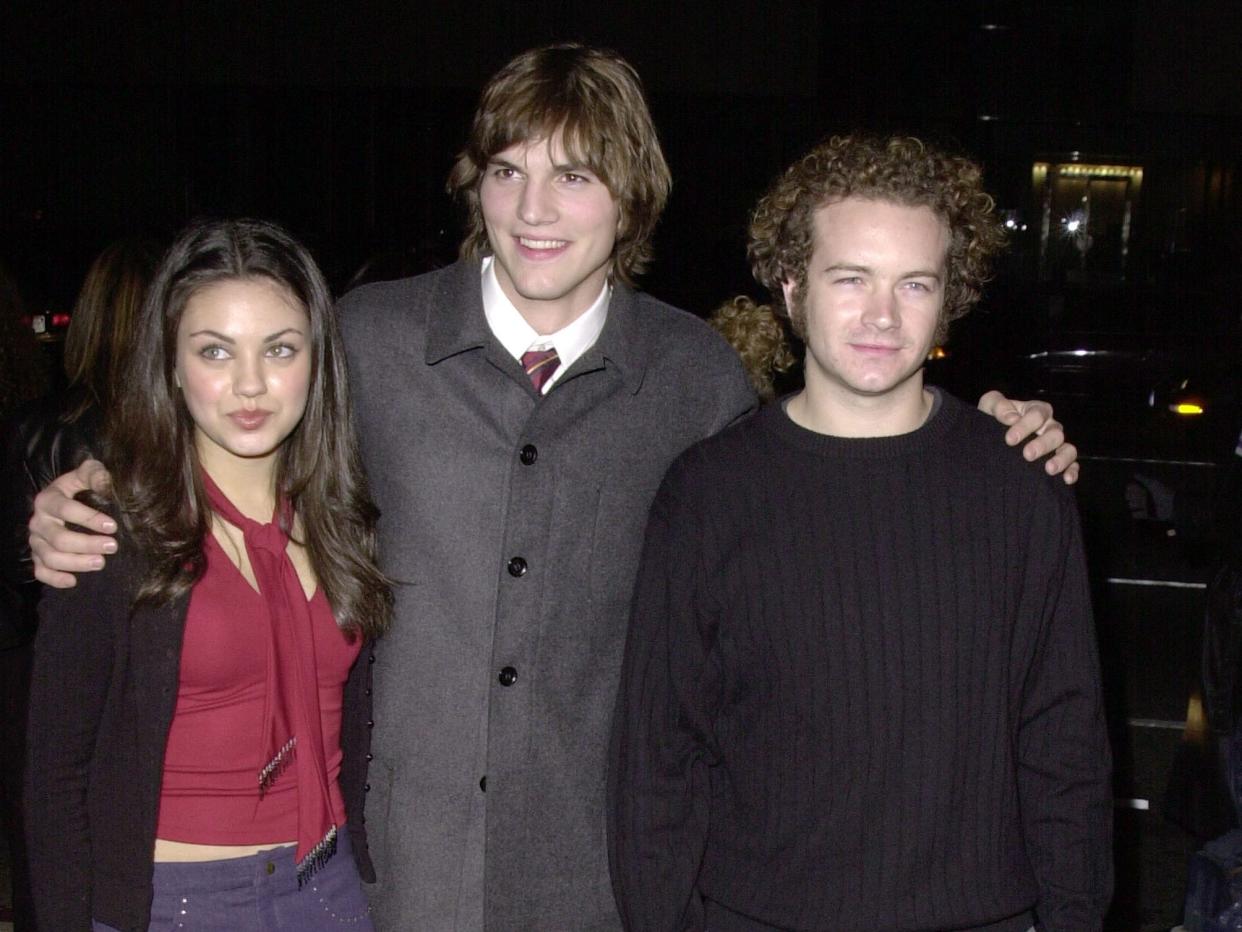 Mila Kunis, Ashton Kutcher, and Danny Masterson at a Los Angeles premiere in 2000.