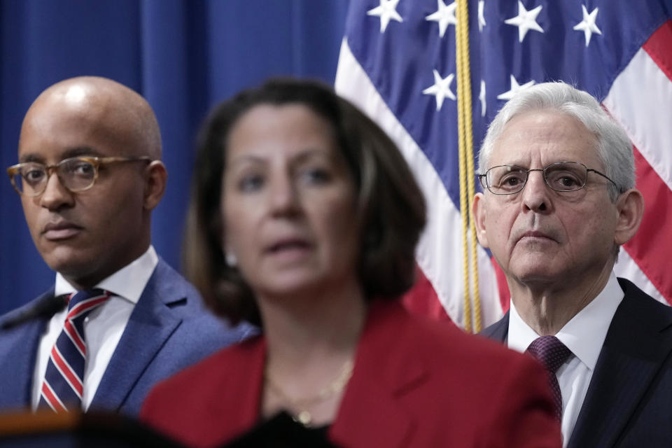 Attorney General Merrick Garland, right, and United States Attorney for the Southern District of New York Damian Williams, left, listen as Deputy Attorney General Lisa Monaco, center, speaks during a news conference at the Justice Department in Washington, Friday, April 14, 2023. The Justice Department has charged 28 members of Mexico’s powerful Sinaloa cartel, including sons of notorious drug lord Joaquin “El Chapo” Guzman, in a sprawling fentanyl-trafficking investigation. (AP Photo/Susan Walsh)