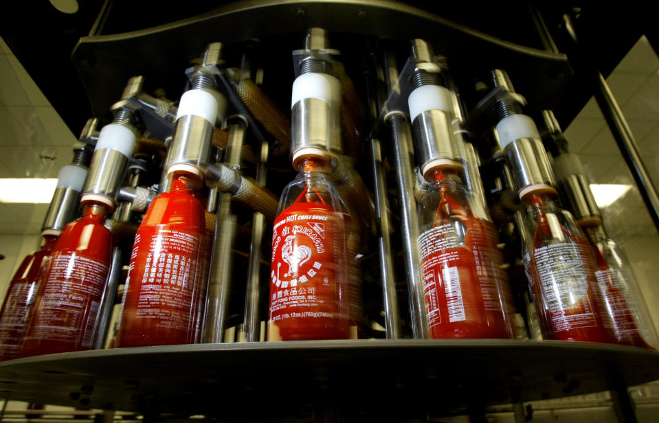 In this Jan. 28, 2005 photo, bottles of Sriracha hot sauce are filled with product at Huy Fong Foods Inc. in Rosemead, Calif. The city of Irwindale, where Huy Fong has a production facility, on Monday, Oct. 28, 2013 filed a lawsuit in Los Angeles Superior Court asking a judge to stop production at the factory, claiming the chili odor emanating from the plant is a public nuisance. (AP Photo/San Gabriel Valley Tribune, Greg Andersen) MAGS OUT; NO SALES; MANDATORY CREDIT