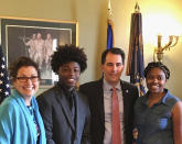 In this Aug. 23, 2017 photo provided by Durante Carr, Amy Gannon, from left, her friend AJ Carr, former Wisconsin Gov. Scott Walker and AJ's mother Dorecia Carr pose for a photo at the state Capitol in Madison, Wisconsin. Gannon, who mentored AJ Carr and became friends with his family, was aboard a helicopter that crashed Thursday, Dec. 26, 2019, in Hawaii along with her 13-year-old daughter. (Durante Carr via AP)