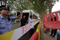 Police prepare barricades outside a Jinan court ahead of the sentencing of Bo Xilai, on September 21, 2013. The disgraced politician has been sentenced by a court to life in prison, following a sensational scandal that culminated in the country's highest-profile trial in decades