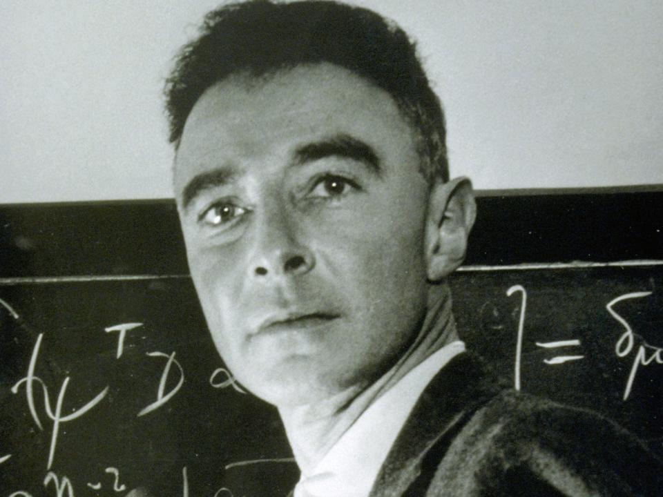 J. Robert Oppenheimer writes on a blackboard.