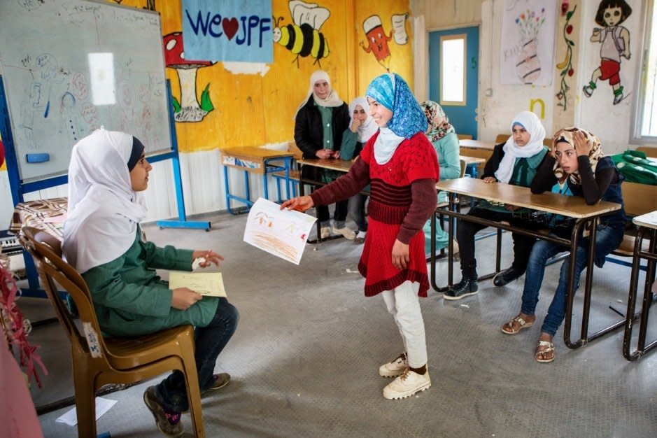 Omaima attends to one of her students.