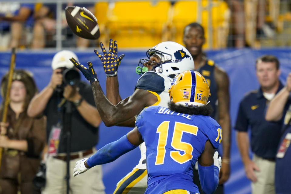 West Virginia wide receiver Bryce Ford-Wheaton makes a catch for a touchdown past Pittsburgh defensive back Rashad Battle (15 )during the second half of an NCAA college football game Thursday, Sept. 1, 2022, in Pittsburgh. Pittsburgh won 38-31. (AP Photo/Keith Srakocic)