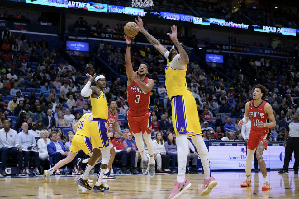 New Orleans Pelicans guard CJ McCollum (3) has his shot blocked by Los Angeles Lakers forward Anthony Davis (3) in the second half of an NBA basketball game in New Orleans, Tuesday, March 14, 2023. (AP Photo/Matthew Hinton)