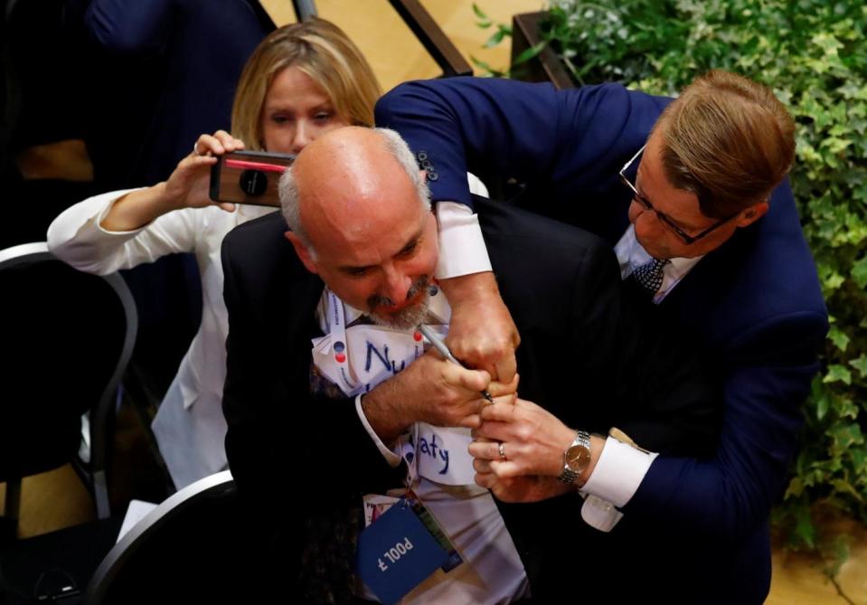 The man was wrestled out just before Mr Turmp and Mr Putin arrived (Reuters)