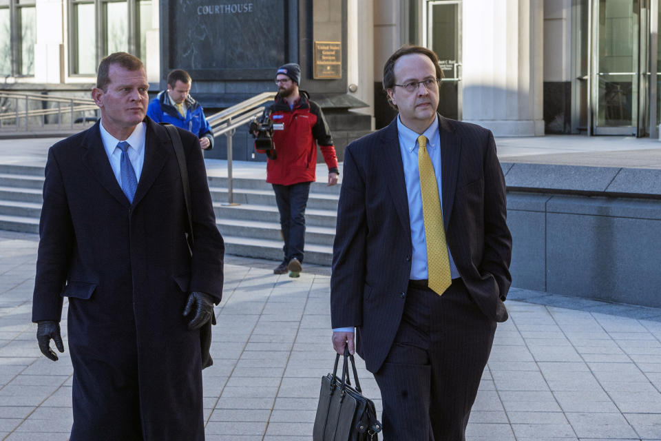 Former West Virginia Supreme Court Justice Allen Loughry, right, emerges with his lawyer John Carr from the Robert C. Byrd United States Courthouse after his sentencing, Wednesday, Feb. 13, 2019 in Charleston, W.Va. Loughry, a former West Virginia Supreme Court justice who had a $32,000 blue suede couch in his office and was at the center of an impeachment scandal has been sentenced to two years behind bars. (Craig Hudson/Charleston Gazette-Mail via AP)