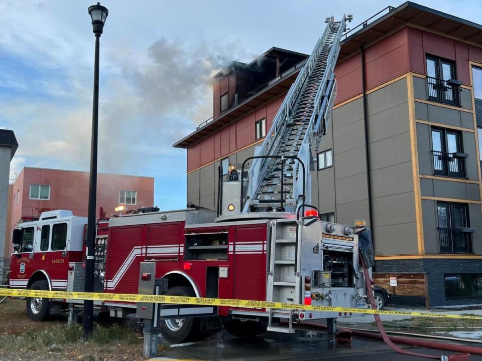 Crews were still on site at 6:30 p.m. on Sunday answering a call for smoke and fire on top of the building on 6th Ave. and Main Street. (Sissi De Flaviis/CBC - image credit)