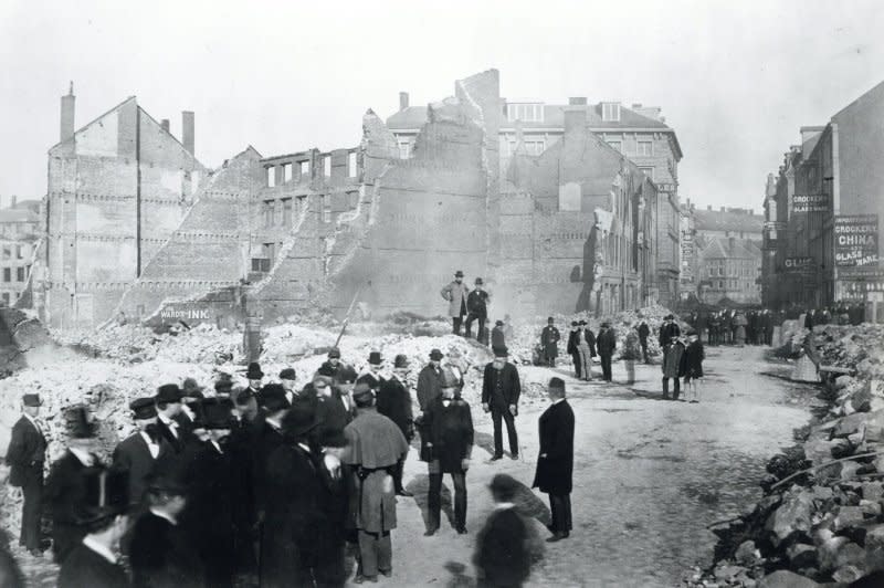 Officials observe the aftermath of the Great Boston Fire. In 1872, a fire which began in the basement of a warehouse in downtown Boston raged for 12 hours, consuming 65 acres and leaving 776 buildings in ruins. Thirty people died. File Photo courtesy of the City of Boston Archives