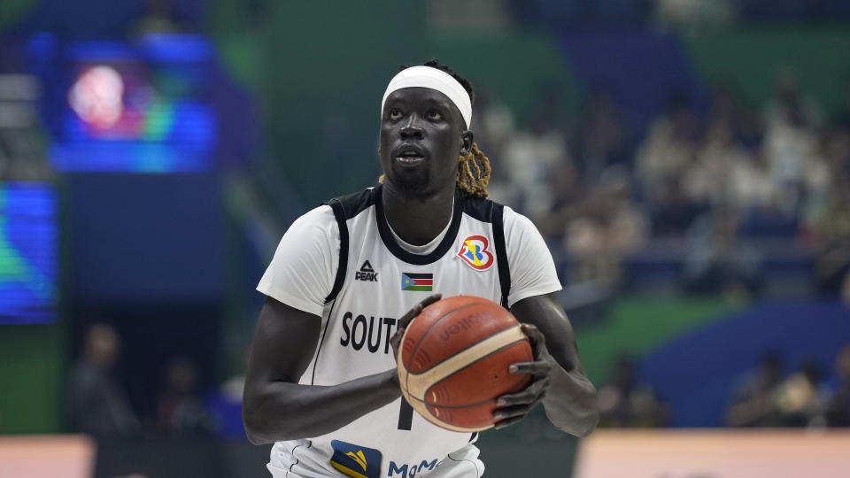 FILE - South Sudan forward Nuni Omot looks to shoot against Puerto Rico during a Basketball World Cup group B match in Quezon City, Philippines,, Aug. 26, 2023. “A lot of guys are refugees. And we grew up, we moved, so we’ve had the luxuries of having indoor courts and such things,” Omot said about the team. “To go back home and start kind of at the beginning, obviously, we all had a vision of what it could be. It’s just a testament that’s going to show in the future.” (AP Photo/Aaron Favila, File)