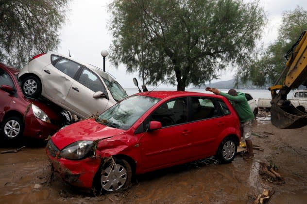 Damaged cars are pilled up in the mud after a record rainfall in Milina village, Pilion region, central Greece, Wednesday, Sept. 6, 2023. Rescue teams in Turkey, Greece and Bulgaria have recovered more bodies following floods after fierce rainstorms. (AP Photo/Thodoris Nikolaou)