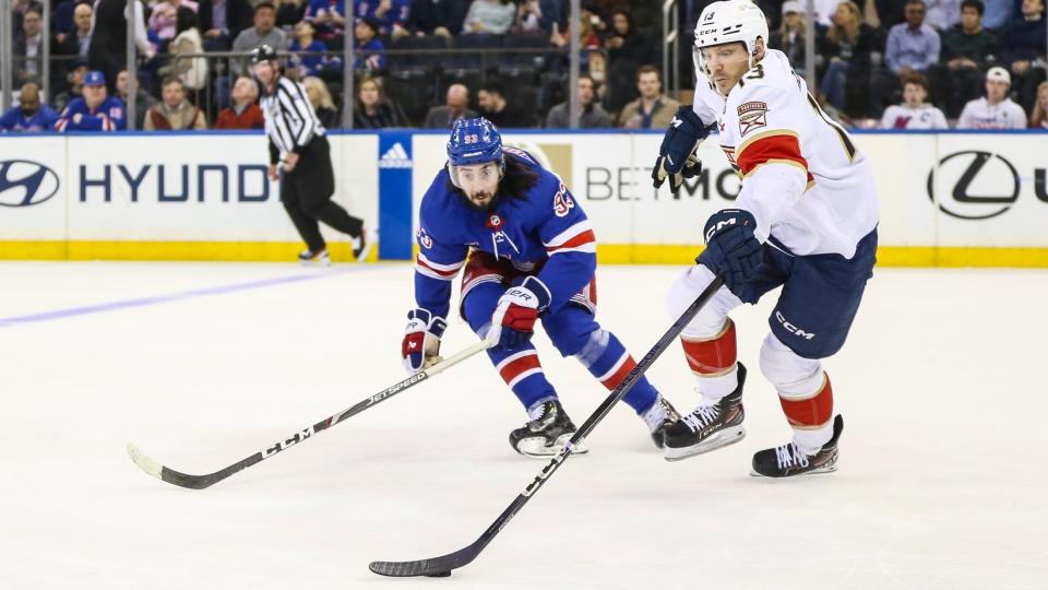 Mar 4, 2024; New York, New York, USA; New York Rangers center Mika Zibanejad (93) and Florida Panthers center Sam Reinhart (13) chases the puck in the first period at Madison Square Garden