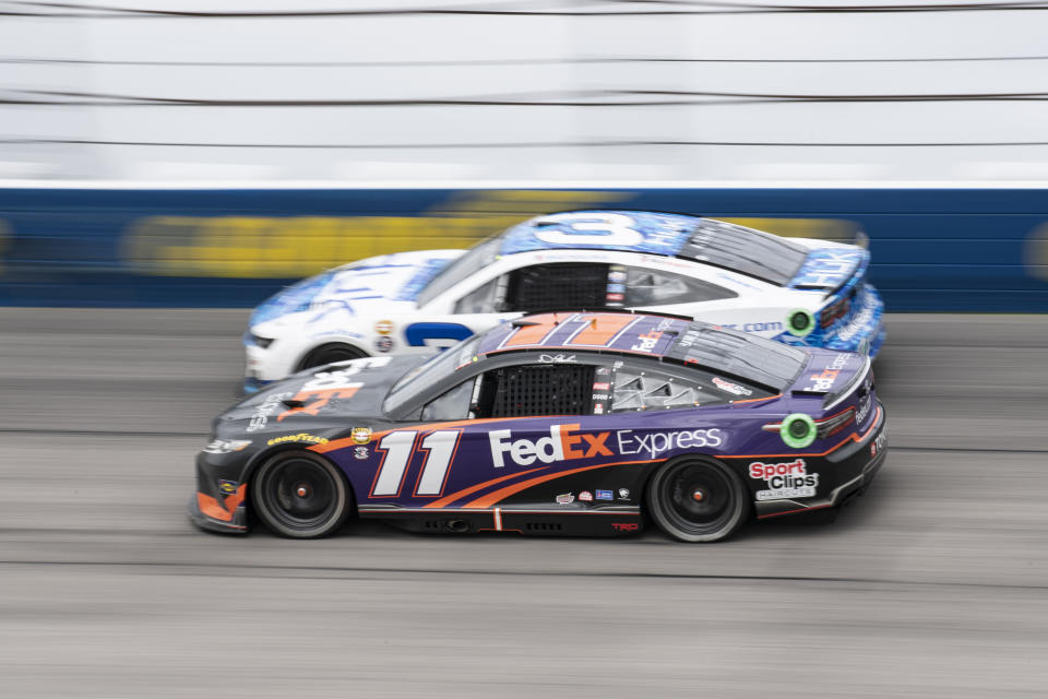 Denny Hamlin (11) attempts to pass Austin Dillon (3) during a NASCAR Cup Series auto race at Darlington Raceway, Sunday, May 8, 2022, in Darlington, S.C. (AP Photo/Matt Kelley)