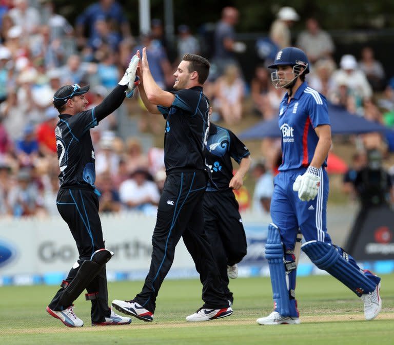 New Zealand's Mitchell McClenaghan (C) and Brendon McCullum (L) celebrate during their ODI against England on Febuary 17, 2013. McClenaghan was unable to complete his final over and limped from the field after delivering a short ball to claim the penultimate wicket when Steven Finn top-edged to Martin Guptill