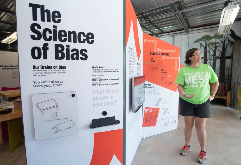 Executive director Megan Pratt gives a tour of the Smithsonian Institution traveling exhibition “The Bias Inside Us” that is being hosted by the Pensacola MESS Hall in Pensacola on July 13, 2023.  The Smithsonian community engagement project that raises awareness about the social science and psychology of implicit bias will run from July 15 to Aug. 15.