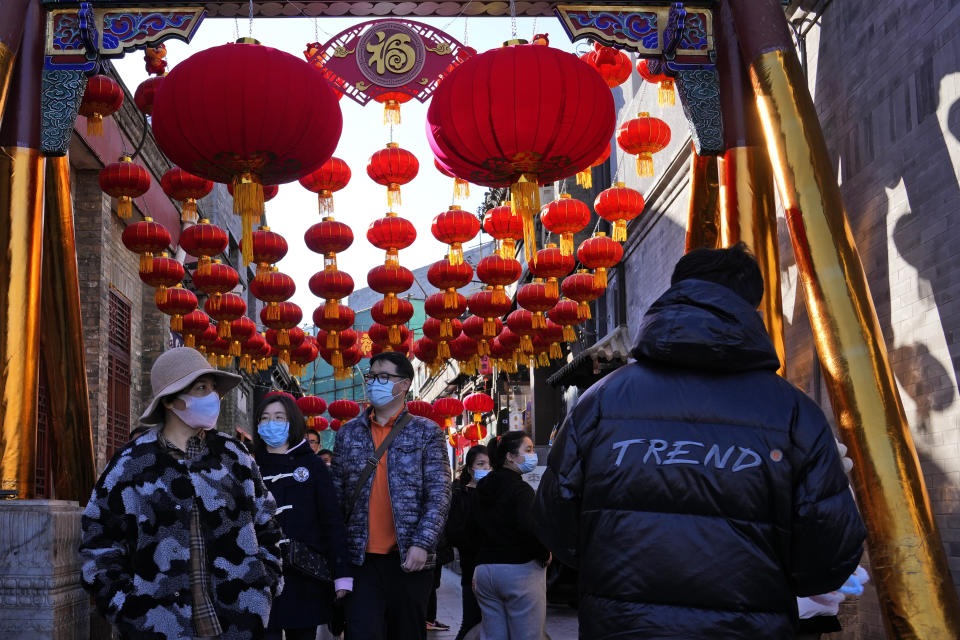 FILE - Shoppers visit a popular retail street in Beijing on Saturday, Feb. 26, 2022. Developing economies in Asia have mostly regained ground lost during the pandemic but are seeing their recoveries stall as productivity lags, the World Bank said in a report released Friday, March 31, 2023. (AP Photo/Ng Han Guan, File)