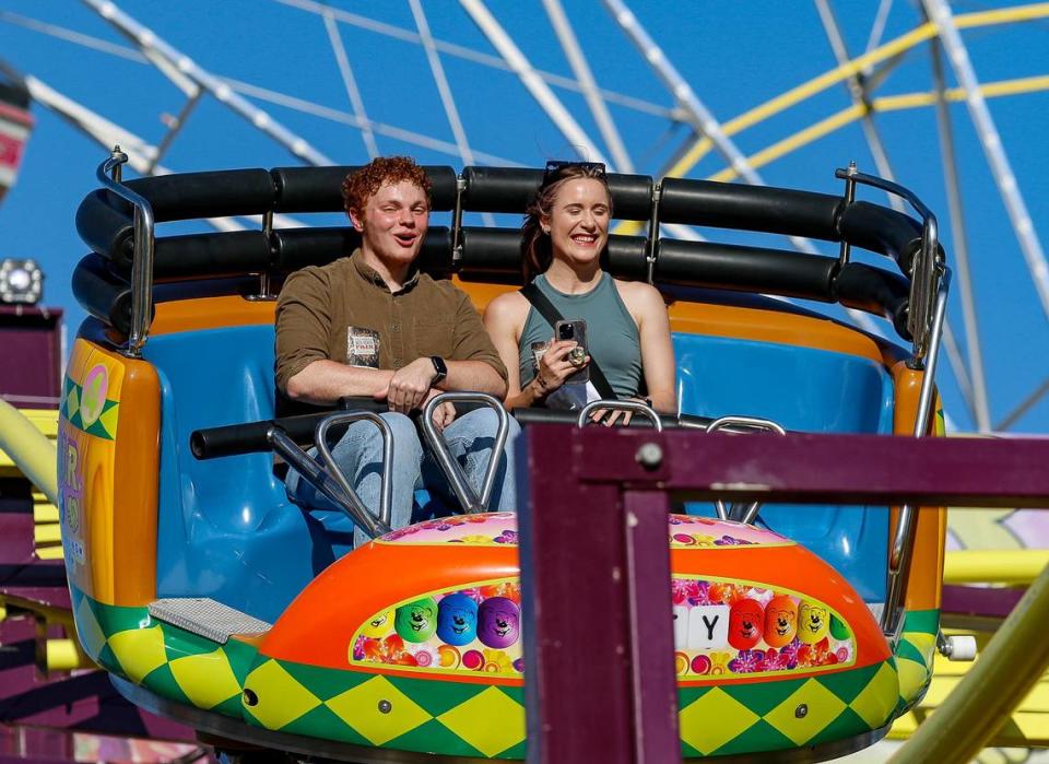 Tribune reporters John Lynch and Chloe Jones ride the P.L.U.R. Spinning Coaster at the Mid-State Fair on July 20, 2023.