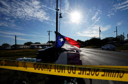 A recently hung Texas state flag flies near the site of the shooting at the First Baptist Church of Sutherland, Texas, U.S., November 6, 2017. REUTERS/Rick Wilking