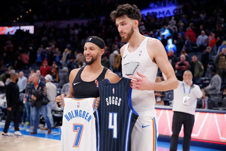 Thunder forward Chet Holmgren (7) and Magic guard Jalen Suggs (4) trade jerseys following a game at Paycom Center on Jan. 13.