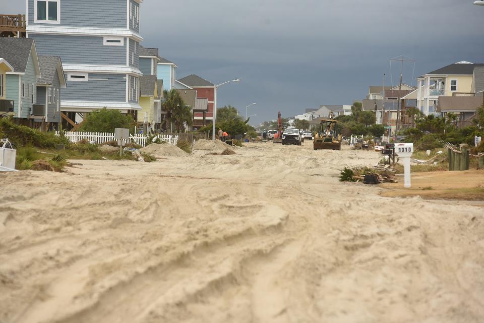 West Beach Drive in Oak Island is full of sand washed inland by Hurricane Isaias on Thursday Aug. 6, 2020.