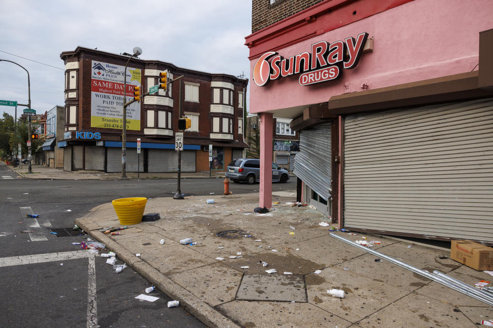 Debris and damage sit outside SunRay Drugs Wednesday morning, Sept. 27, 2023, in Philadelphia, after it was looted Tuesday night. A flash mob-style ransacking and vandalism to downtown stores Tuesday night came after a peaceful protest over a judge’s decision to dismiss murder and other charges against a Philadelphia police officer who shot and killed a driver, Eddie Irizarry, through a rolled-up window. (Alejandro A. Alvarez/The Philadelphia Inquirer via AP)