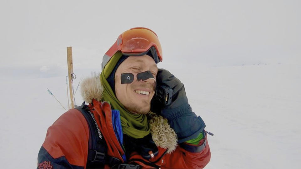 In this photo provided by Colin O'Brady, of Portland., Ore., he speaks on the phone in Antarctica on Wednesday, Dec. 26, 2018. He has become the first person to traverse Antarctica alone without any assistance. O'Brady finished the 932-mile (1,500-kilometer) journey across the continent in 54 days, lugging his supplies on a sled as he skied in bone-chilling temperatures. (Colin O'Brady via AP)