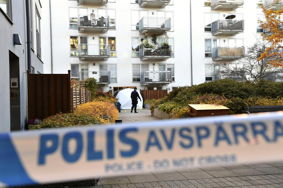 Forensic police work on the site where Swedish rapper Einar was shot to death, in Hammarby Sjostad district in Stockholm, Friday, Oct. 22, 2021. An award-winning 19-year-old Swedish rapper was shot to death in southern Stockholm in an incident that media reports on Friday suggested could be gang-related. The rapper Einar was struck by several bullets in the Hammarby suburb south of central Stockholm and died on the spot late Thursday, police spokesman Ola Osterling told the Swedish news agency TT. (Henrik Montgomery/TT via AP)