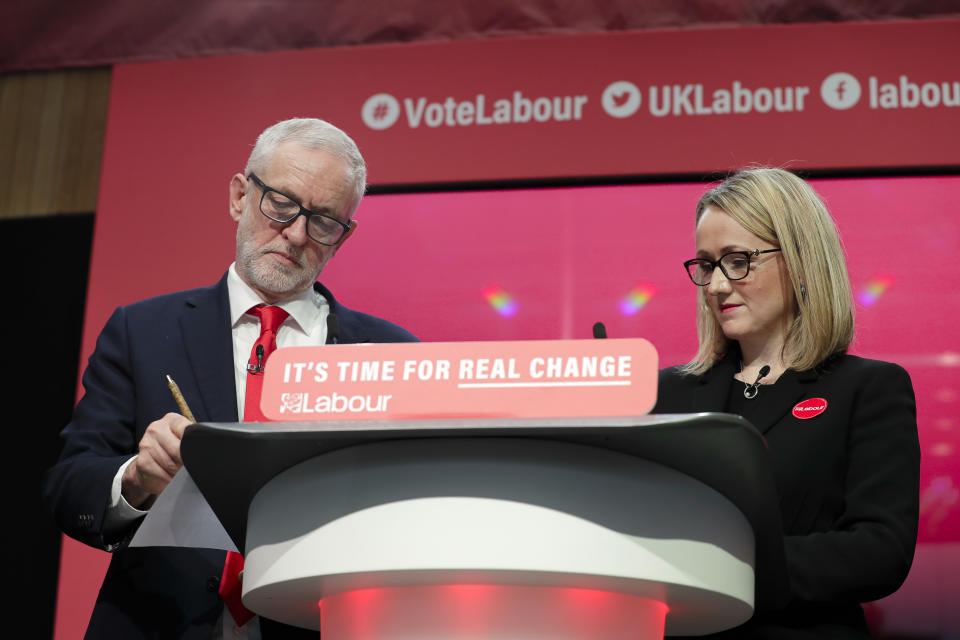 Jeremy Corbyn, Leader of Britain's opposition Labour Party, stands next to Rebecca Long-Bailey on stage at the launch of Labour's General Election manifesto, at Birmingham City University, England, Thursday, Nov. 21, 2019. Britain goes to the polls on Dec. 12. (AP Photo/Kirsty Wigglesworth)