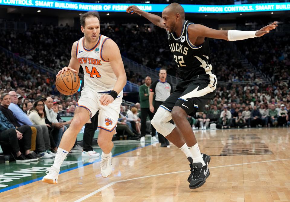 New York Knicks forward Bojan Bogdanovic is guarded by Milwaukee Bucks forward Khris Middleton during the first half of their game Sunday, April 7, 2024, at Fiserv Forum in Milwaukee.