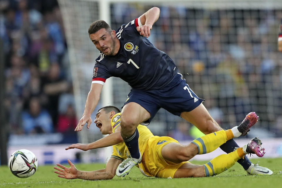 Scotland's John McGinn, top, duels for the ball with Ukraine's Taras Stepanenko during the World Cup 2022 qualifying play-off soccer match between Scotland and Ukraine at Hampden Park stadium in Glasgow, Scotland, Wednesday, June 1, 2022. (AP Photo/Scott Heppell)