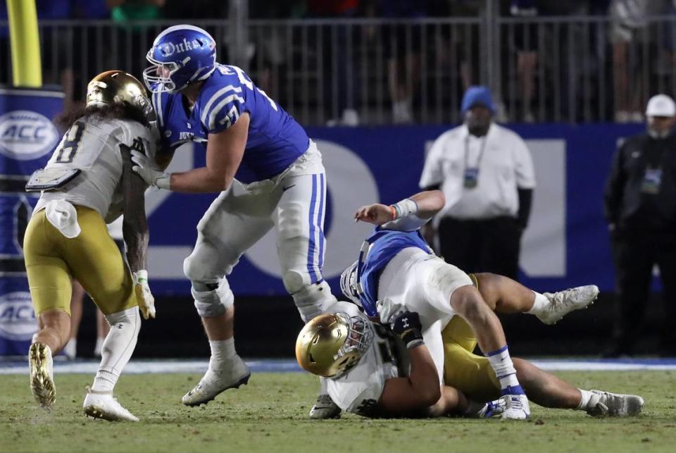 Duke’s Riley Leonard (13) is taken down during a play late in the fourth quarter of the Blue Devils’ 21-14 loss to Notre Dame at Wallace Wade Stadium on Saturday, Sept. 30, 2023, in Durham, N.C.