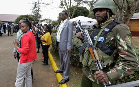 A police officer stands guard at the national tallying centre as Kenyans await the announcement on Friday - Credit: EPA