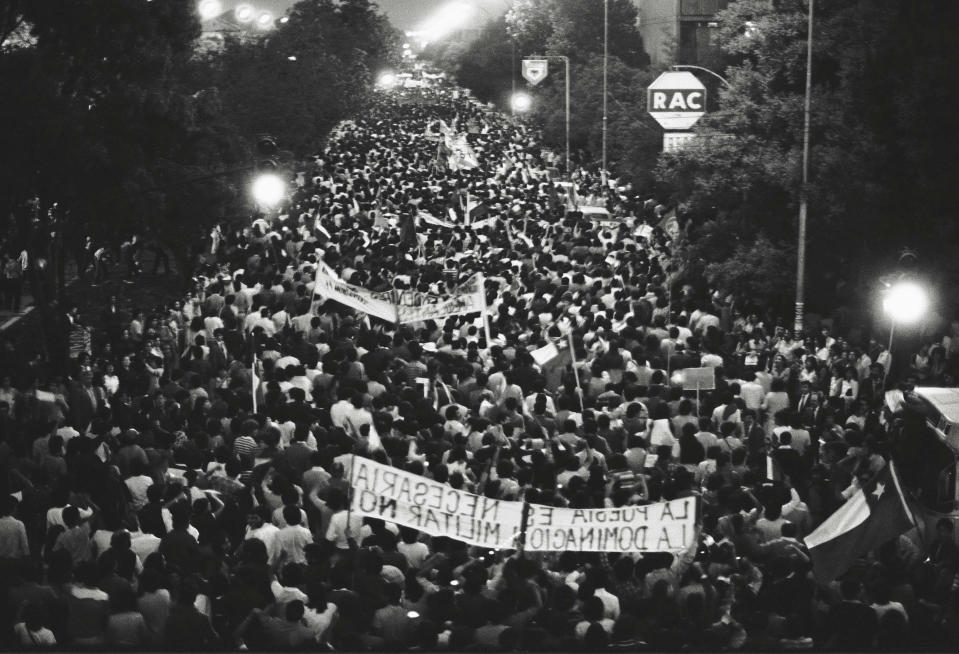 People march along Matta Avenue to protest the dictatorship of General Augusto Pinochet in Santiago, Chile, Nov. 1982. (AP Photo/Marco Ugarte)
