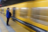 A commuter stands on a platform as a subway races past in downtown in Buenos Aires, Argentina, Monday, June 17, 2019. As lights turned back on across Argentina, Uruguay and Paraguay after a massive blackout that hit tens of millions people, authorities were still largely in the dark about what caused the collapse of the interconnected grid and were tallying the damage from the unforeseen disaster. (AP Photo/Tomas F. Cuesta)