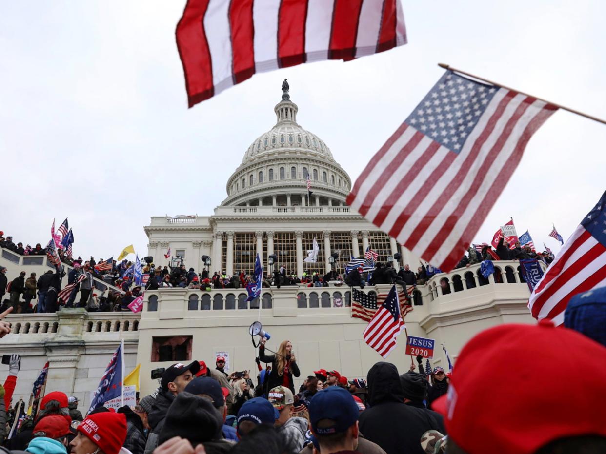 In this Wednesday 6 January 2021 file photo, supporters of Donald Trump gather outside the US Capitol in Washington, DC ((Associated Press))