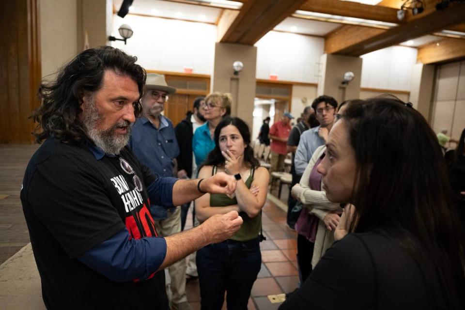 Ilya Tarshansky speaks Thursday with Carmit Novitzky, right, and Dror Kohler, center, about his experience in the Oct. 7th Hamas attack in Israel after his presentation at the Folsom Community Center.