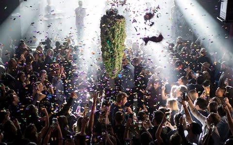 A depiction of a cannabis bud drops from the ceiling at Leafly's countdown party in Toronto on Wednesday - Credit:  Chris Young