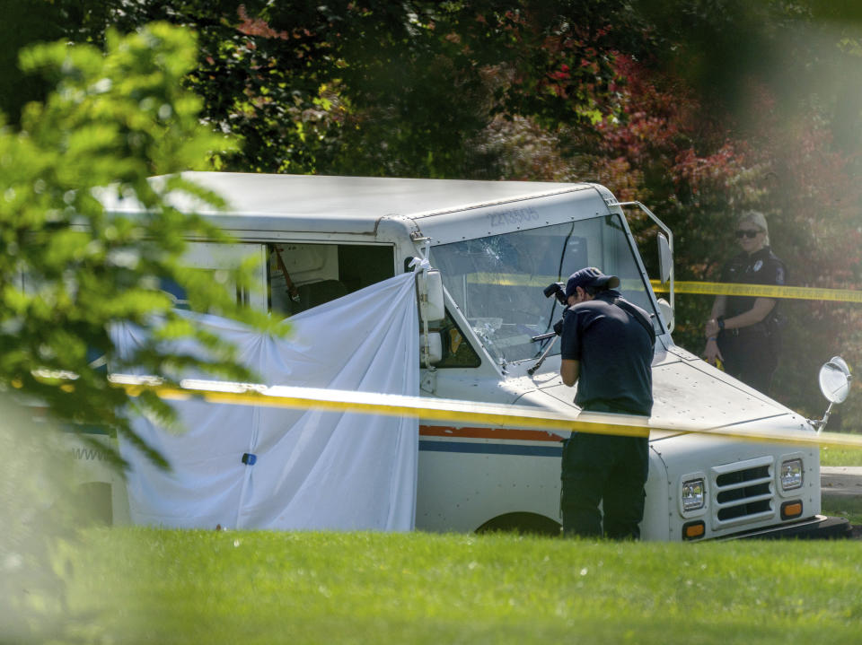 Police investigate the scene of a fatal shooting of a postal worker in front of a house on Suburban Ave. in Collier Township, Pa., outside of Pittsburgh, on Thursday, Oct. 7, 2021. (Andrew Rush/Pittsburgh Post-Gazette via AP)