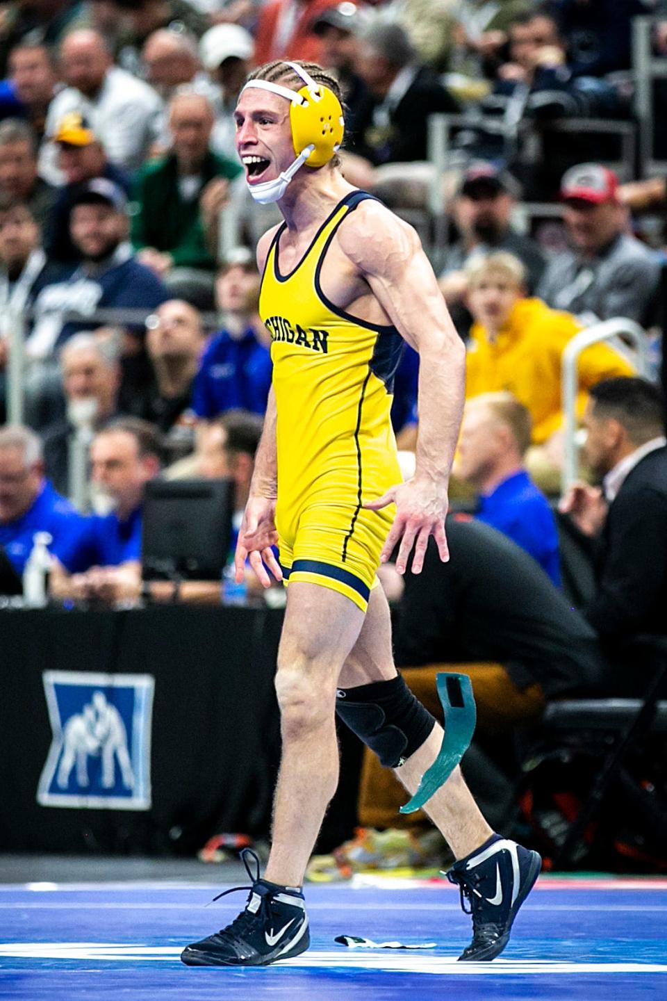 Michigan's Nick Suriano reacts after scoring a fall at 125 pounds in the quarterfinals during the third session of the NCAA Division I Wrestling Championships, Friday, March 18, 2022, at Little Caesars Arena in Detroit, Mich.