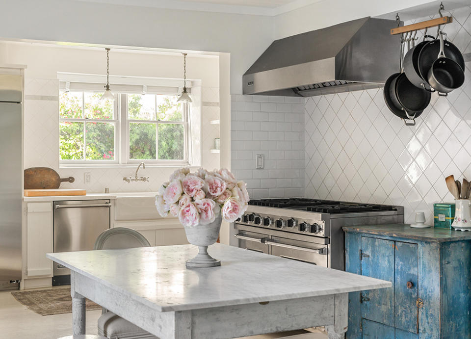 The classically updated kitchen sports a farmhouse sink and top-tier Viking range.