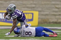 Kansas State wide receiver Chabastin Taylor (13) is tackled by Kansas cornerback Kyle Mayberry (8) during the second half of an NCAA college football game Saturday, Oct. 24, 2020, in Manhattan, Kan. Kansas State won 55-14. (AP Photo/Charlie Riedel)