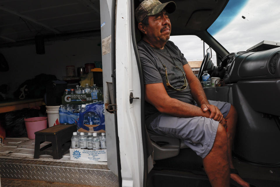 Jesus Vasquez sits in his van waiting to return to his home near Lahaina.  / Credit: Robert Gauthier / Getty Images