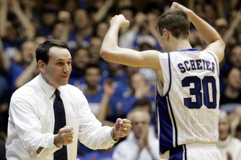 An exultant Mike Krzyzewski congratulates a player in 2009