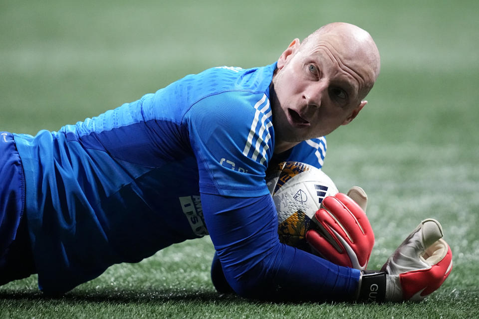 Atlanta United goalkeeper Brad Guzan (1) lies on the pitch after a save against CF Montréal during the second half of a MLS soccer match, Saturday, Sept. 23, 2023, in Atlanta. (AP Photo/Mike Stewart)