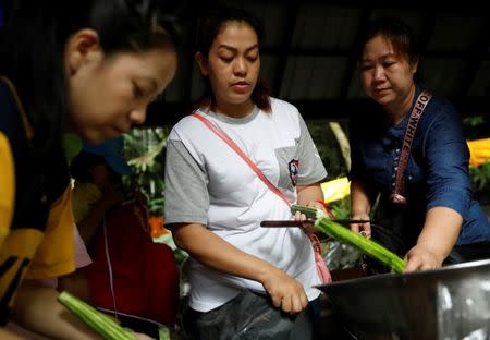 Relatives, of the 12 schoolboys and their soccer coach trapped inside a flooded cave in the Tham Luang cave complex, cook for rescue workers and volunteers near the cave complex in the northern province of Chiang Rai, Thailand, July 7, 2018. REUTERS/Soe Zeya Tun
