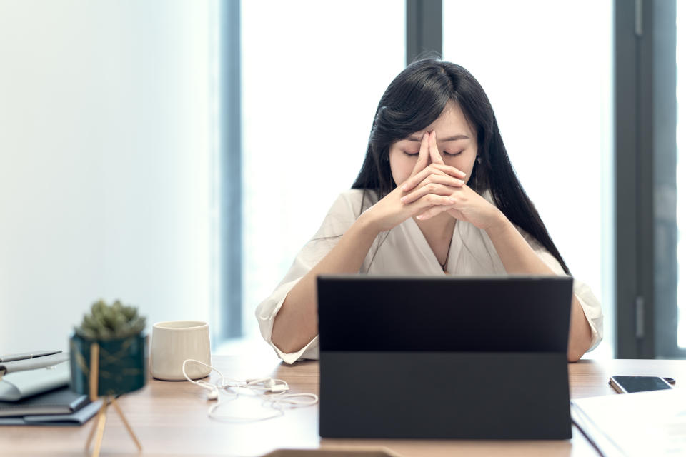 Stressed young businesswoman in the office.