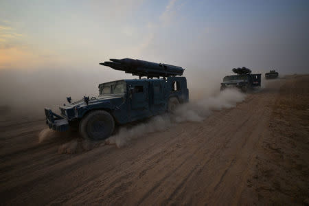 Military vehicles from the Emergency Response Division are seen on the outskirts of Shirqat, Iraq, September 20, 2017. REUTERS/Stringer